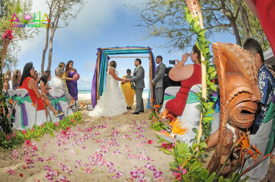 Wedding ceremony couple by the bamboo alter on the beach Riini and Terry
